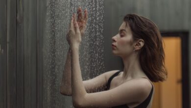 cold showers vs hot showers - person cold shower water