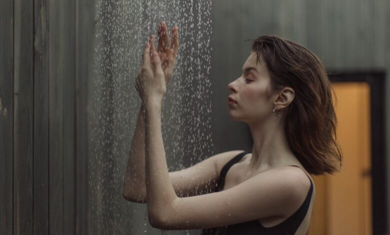cold showers vs hot showers - person cold shower water