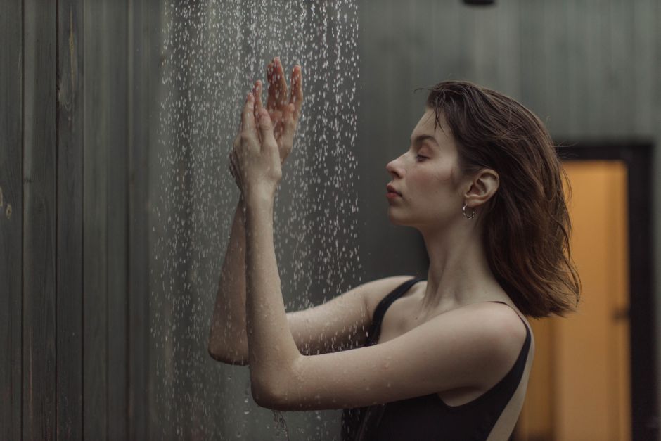 cold showers vs hot showers - person cold shower water