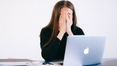 optimization burnout - woman stressed at computer with health data