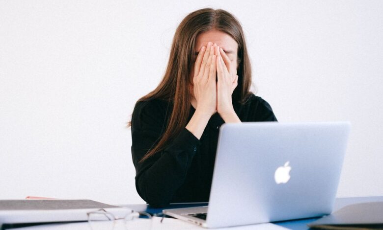 optimization burnout - woman stressed at computer with health data