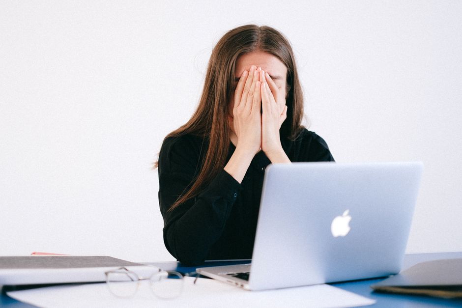 optimization burnout - woman stressed at computer with health data