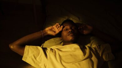 sleep hygiene routine - person sleeping peacefully dark bedroom